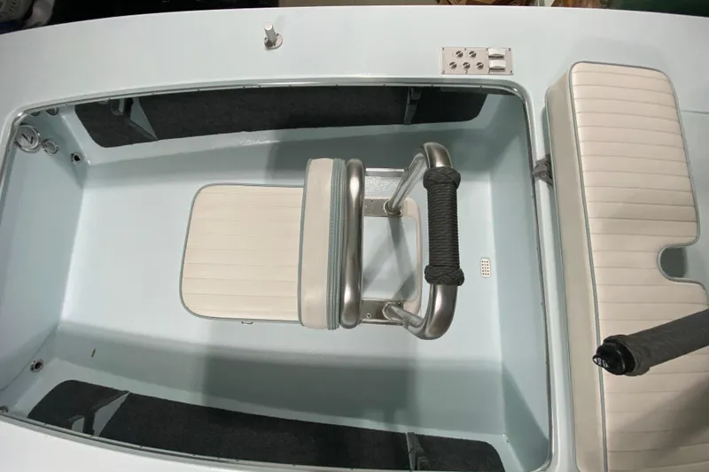 Slide: The Image of 2005 Hell's Bay Devilray boat interior with seating and storage compartments. - 20