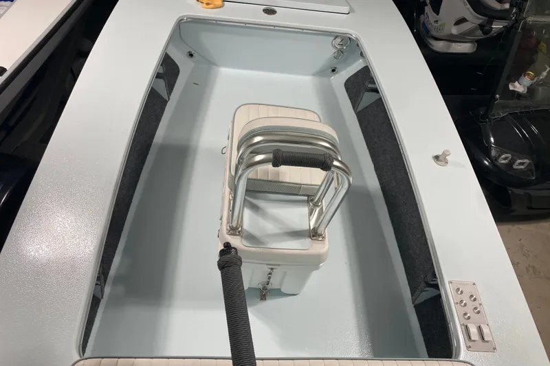 Slide: The Image of 2005 Hell's Bay Devilray boat interior with seating and storage compartments. - 21