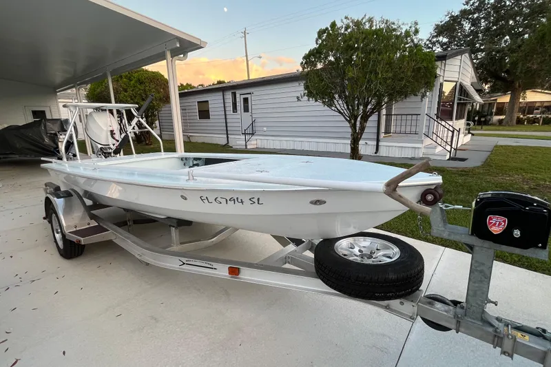 Slide: The Image of 2005 Hell's Bay Devilray boat on trailer parked in residential driveway. - 3