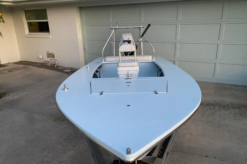 Slide: The Image of 2005 Hell's Bay Devilray boat parked in driveway, front view. - 4