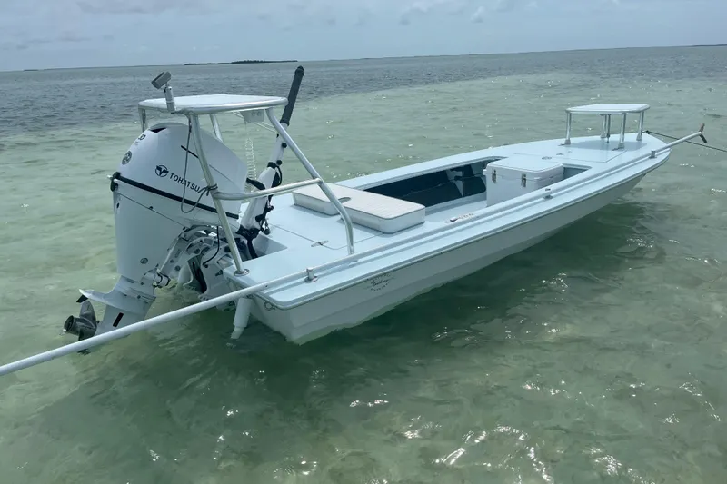 Slide: The Image of 2005 Hell's Bay Devilray boat with Tohatsu engine in shallow water. - 7