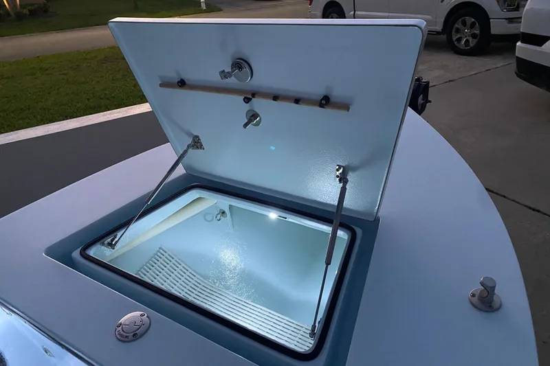 Slide: The Image of Open hatch on 2005 Hell's Bay Devilray boat, illuminated interior, parked on driveway. - 9