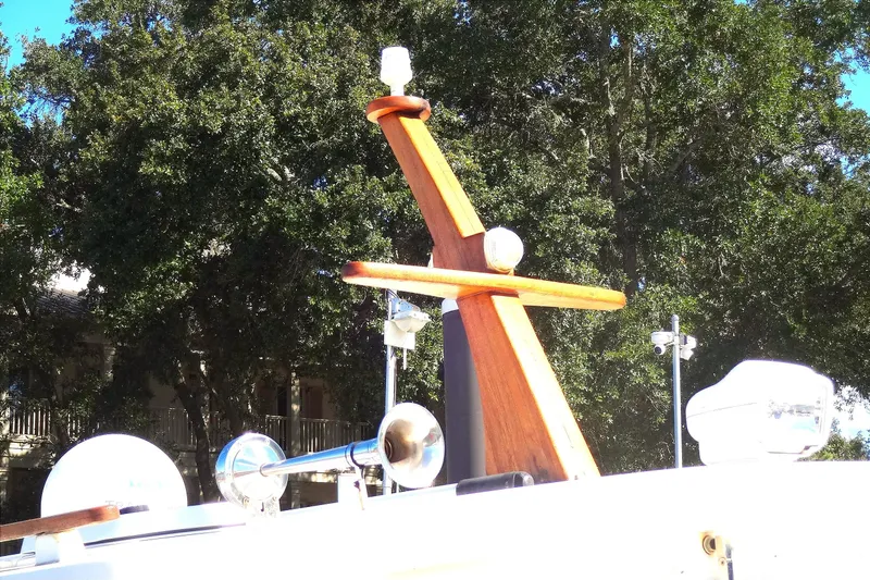 Slide: The Image of 2016 North Aegean Trawler 30 boat with wooden mast and equipment, surrounded by trees. - 18