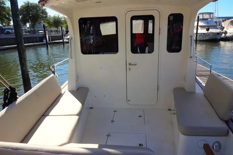 Slide: The Image of 2016 North Aegean Trawler 30 boat interior with seating, docked at marina. - 19