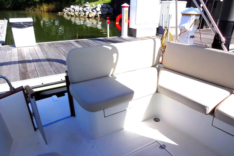 Slide: The Image of 2016 North Aegean Trawler 30 interior with beige seating at dock. - 22