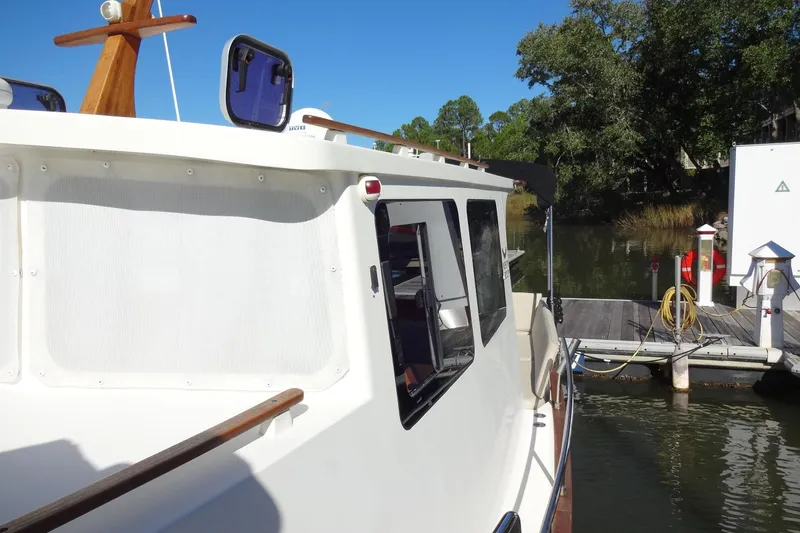 Slide: The Image of 2016 North Aegean Trawler 30 docked by a serene waterfront. - 29
