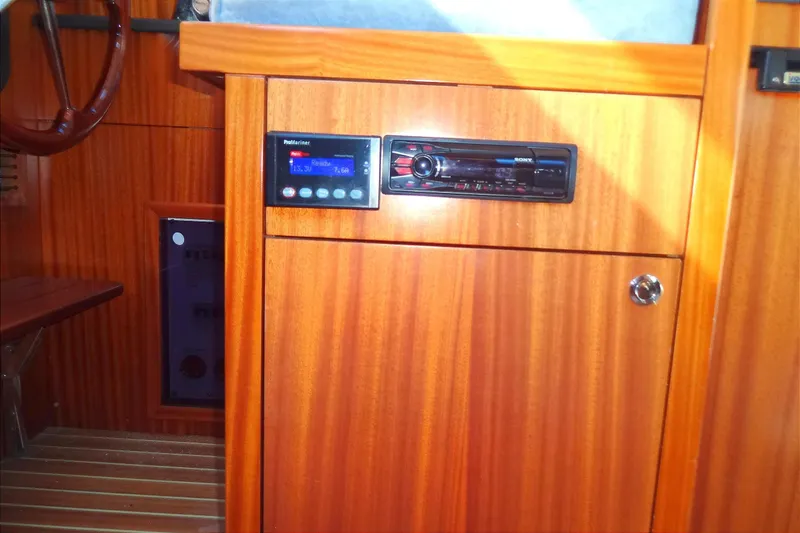 Slide: The Image of Wooden interior of 2016 North Aegean Trawler 30 with control panel and stereo system. - 34