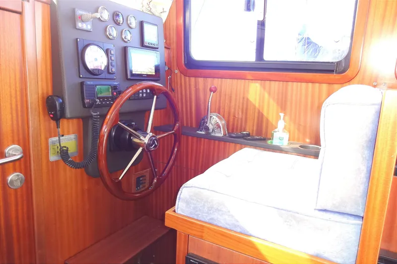 Slide: The Image of 2016 North Aegean Trawler 30 helm with wooden steering wheel and control panel. - 35