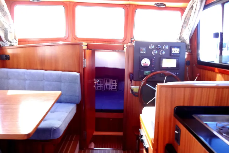 Slide: The Image of Interior of 2016 North Aegean Trawler 30 with helm, seating, and cabin view. - 36