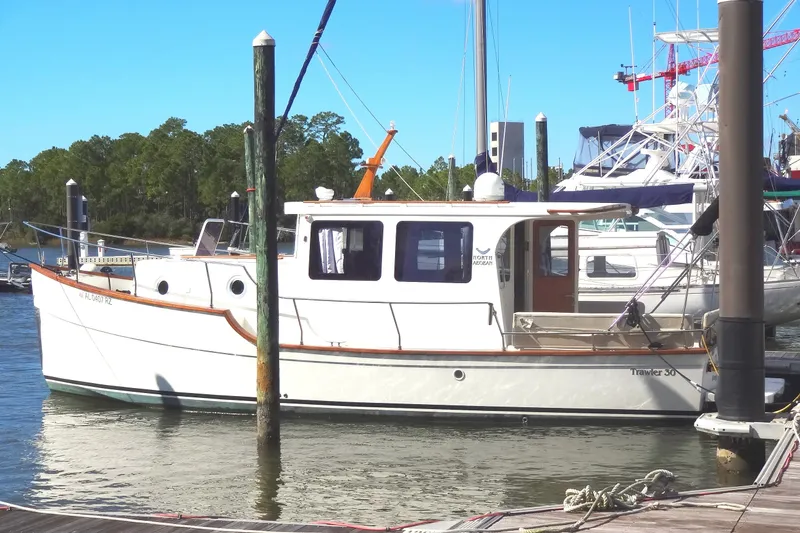 Slide: The Image of 2016 North Aegean Trawler 30 docked at a marina, surrounded by other boats. - 4
