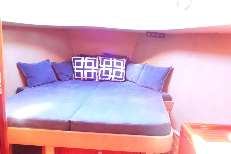 Slide: The Image of Cozy cabin interior of 2016 North Aegean Trawler 30 with blue cushions and geometric pillows. - 42