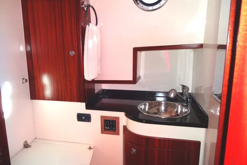 Slide: The Image of Compact bathroom in 2016 North Aegean Trawler 30, featuring wood accents and stainless steel sink. - 43