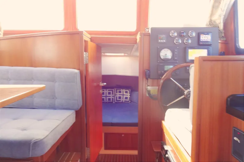 Slide: The Image of Interior of 2016 North Aegean Trawler 30 with helm, seating, and cabin view. - 45