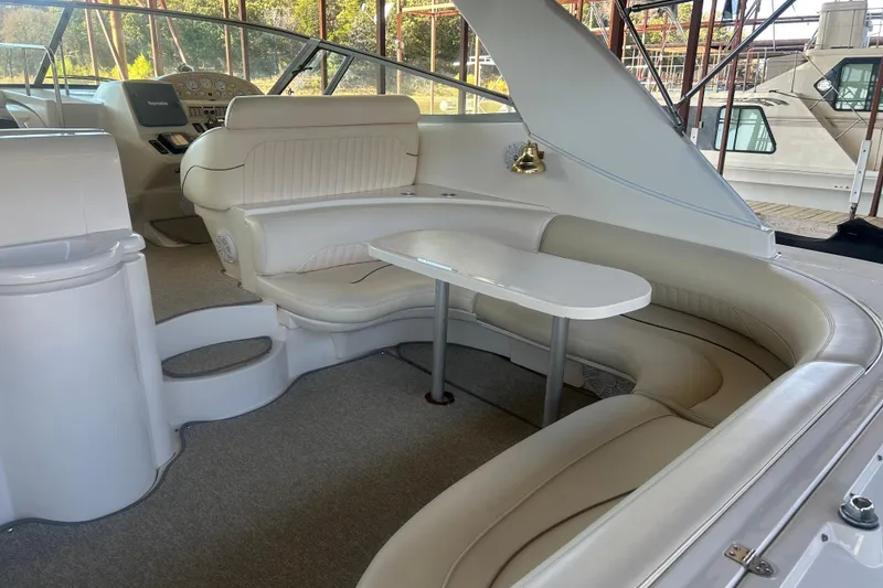 Slide: The Image of 1997 Cruisers 4270 yacht interior with plush seating and table. - 10