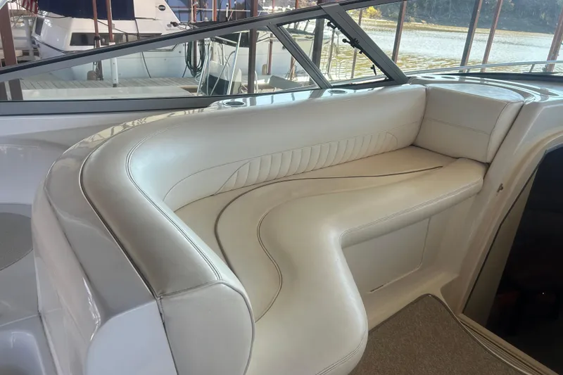 Slide: The Image of Luxurious seating area on a 1997 Cruisers 4270 yacht, featuring white leather upholstery. - 12