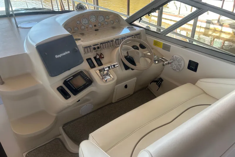 Slide: The Image of 1997 Cruisers 4270 helm with steering wheel, navigation equipment, and control panel. - 14
