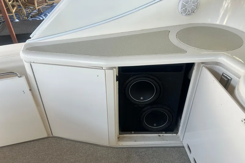 Slide: The Image of 1997 Cruisers 4270 boat with open cabinet revealing dual subwoofers. - 16