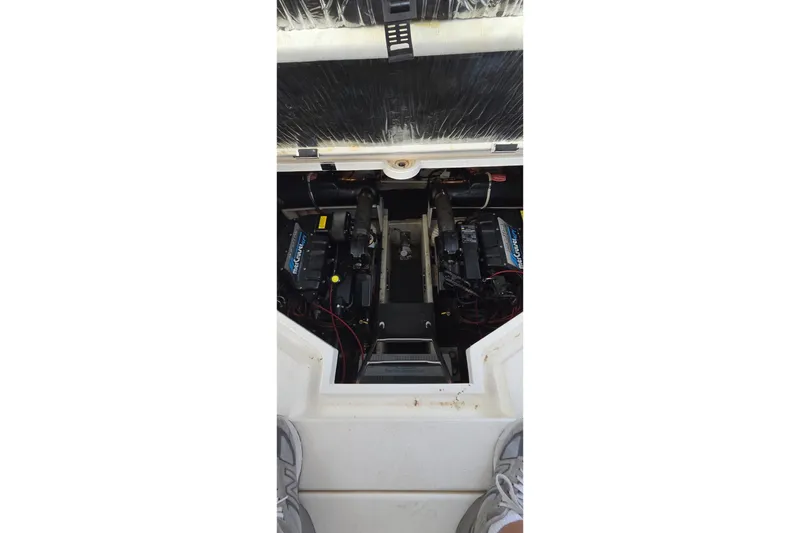 Slide: The Image of Engine compartment of a 1997 Cruisers 4270 boat, featuring dual engines and mechanical components. - 17