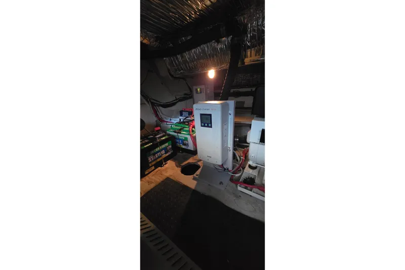 Slide: The Image of Engine room of a 1997 Cruisers 4270 with battery setup and electrical components. - 20