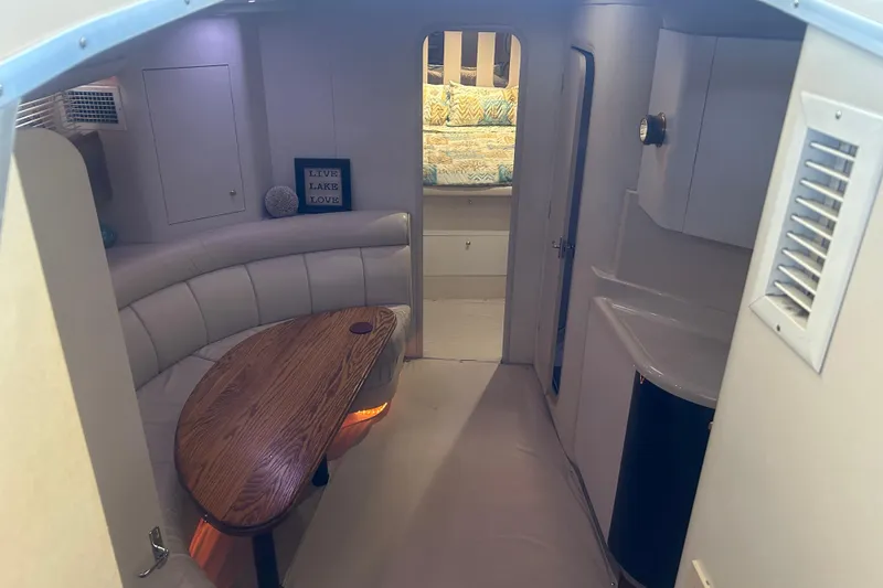 Slide: The Image of 1997 Cruisers 4270 yacht interior with cozy seating and wooden table. - 22