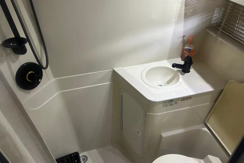 Slide: The Image of Bathroom interior of 1997 Cruisers 4270 yacht with sink and shower fixtures. - 29