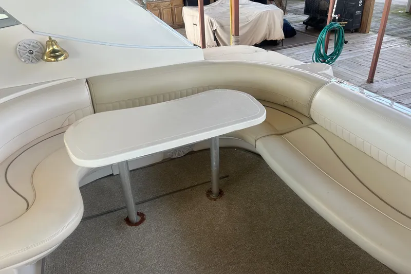 Slide: The Image of 1997 Cruisers 4270 yacht interior with white leather seating and table. - 15