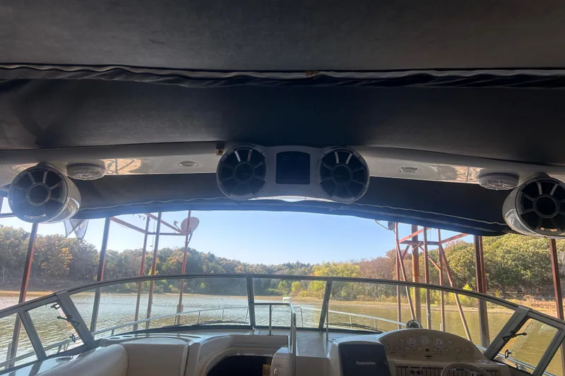 Slide: The Image of Interior view of 1997 Cruisers 4270 boat with speakers and scenic waterway. - 21