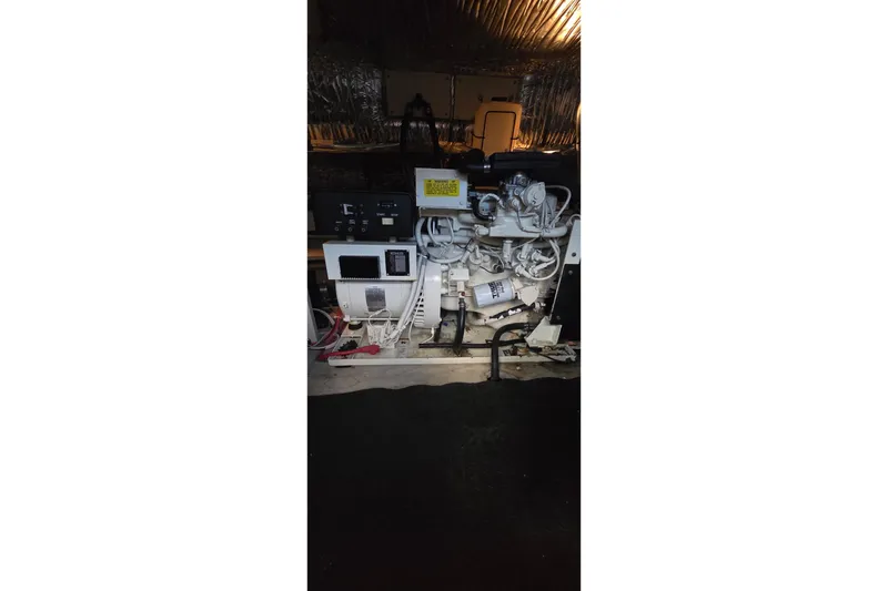 Slide: The Image of Engine compartment of a 1997 Cruisers 4270 boat, showcasing mechanical components and wiring. - 25