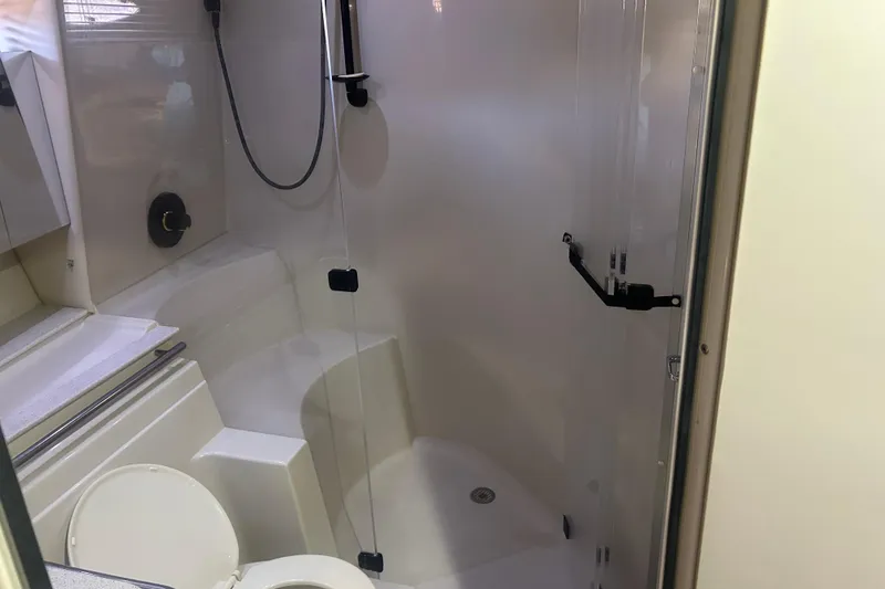 Slide: The Image of Bathroom interior of a 1997 Cruisers 4270 yacht, featuring a shower and toilet. - 31