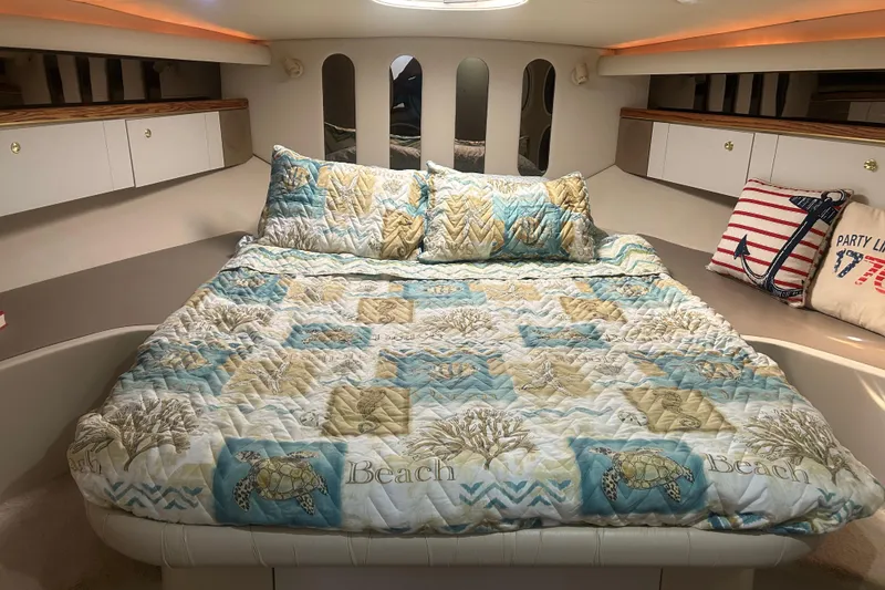 Slide: The Image of Cozy cabin interior of 1997 Cruisers 4270 yacht with nautical-themed bedding. - 32