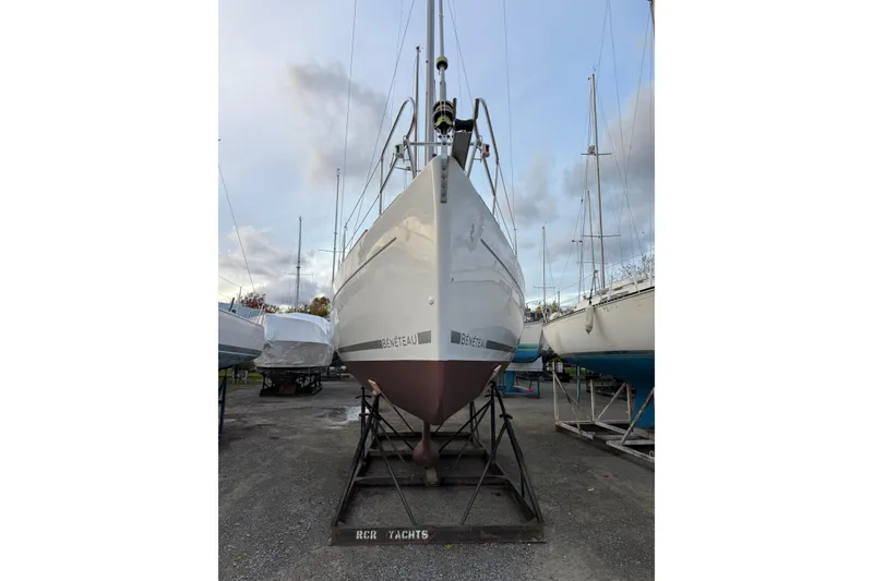 Slide: The Image of 2008 Beneteau 31 sailboat on dry dock, front view, overcast sky. - 1