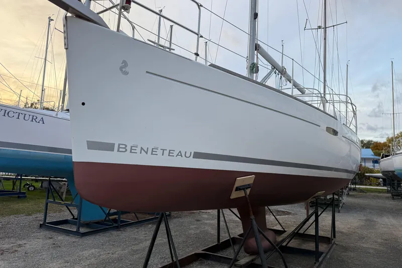 Slide: The Image of 2008 Beneteau 31 sailboat on stands, white hull with red bottom, outdoor setting. - 10
