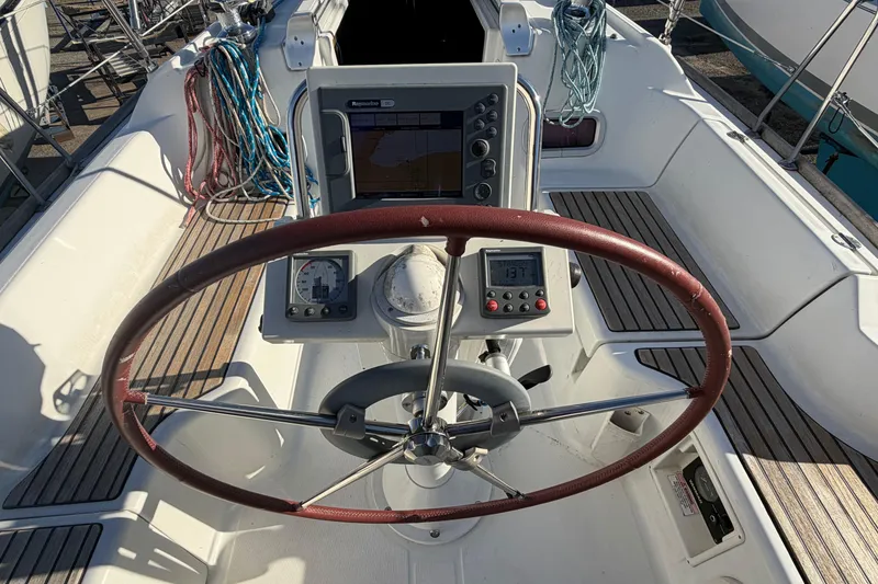 Slide: The Image of Cockpit of 2008 Beneteau 31 sailboat with steering wheel and navigation instruments. - 11