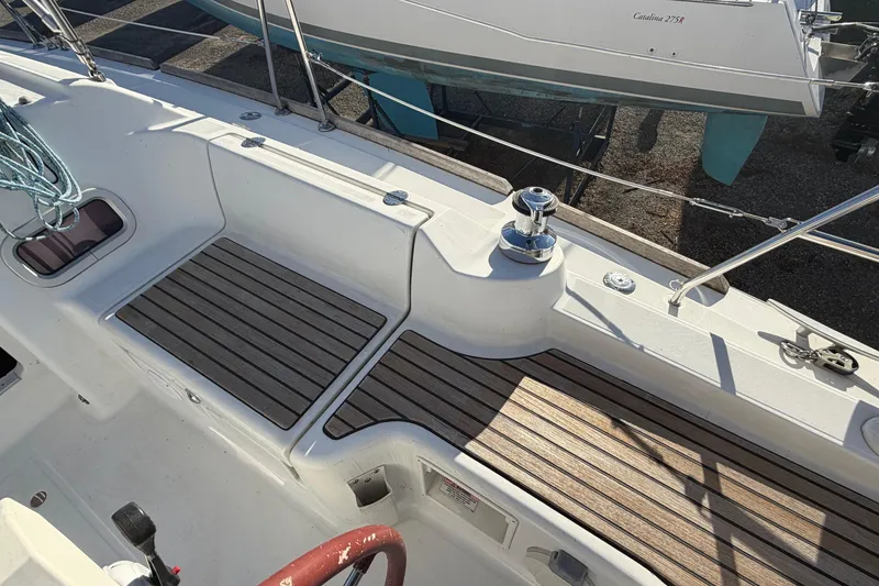 Slide: The Image of 2008 Beneteau 31 sailboat deck with wood accents and winch. - 15