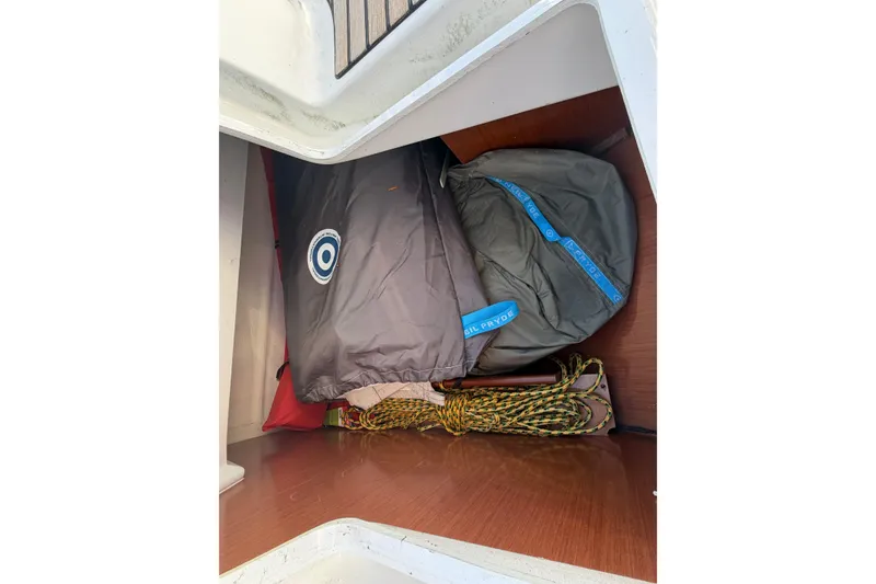 Slide: The Image of Storage compartment on a 2008 Beneteau 31 sailboat with sailing gear and ropes. - 17