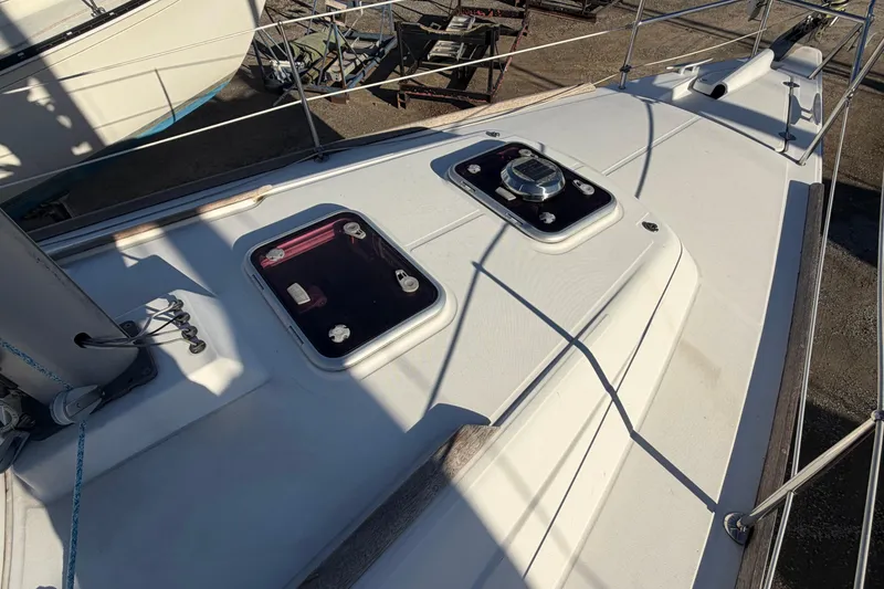 Slide: The Image of Deck of 2008 Beneteau 31 sailboat with hatches and rigging. - 21