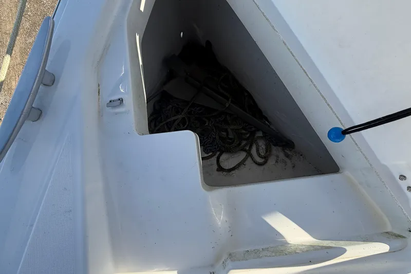 Slide: The Image of Anchor locker of a 2008 Beneteau 31 sailboat with ropes and anchor. - 23