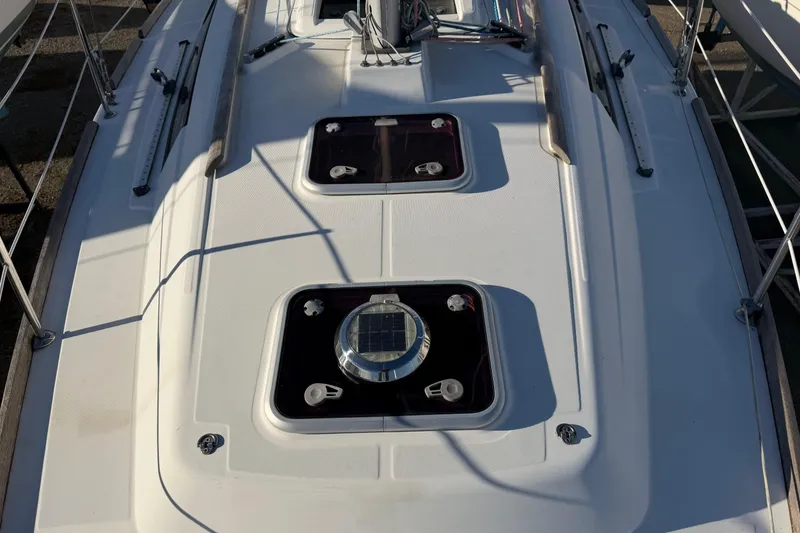 Slide: The Image of Deck view of a 2008 Beneteau 31 sailboat with hatches and fittings. - 24