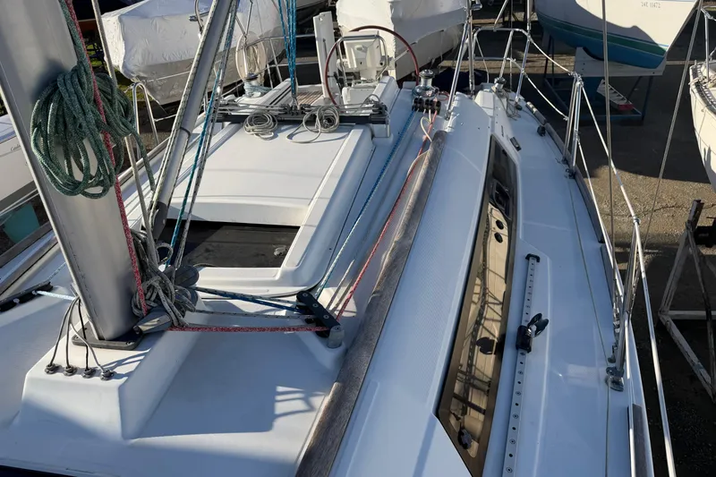 Slide: The Image of 2008 Beneteau 31 sailboat deck with rigging and ropes in marina. - 26