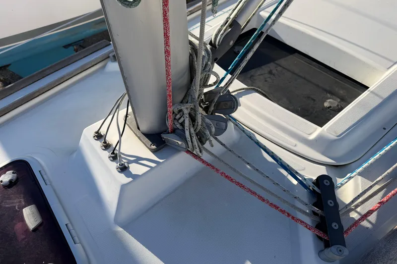 Slide: The Image of Deck rigging of a 2008 Beneteau 31 sailboat, featuring ropes and fittings. - 27