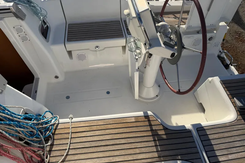Slide: The Image of Cockpit of 2008 Beneteau 31 sailboat with steering wheel and ropes. - 29