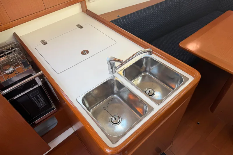 Slide: The Image of Galley kitchen in 2008 Beneteau 31 sailboat with dual sinks and stove. - 34