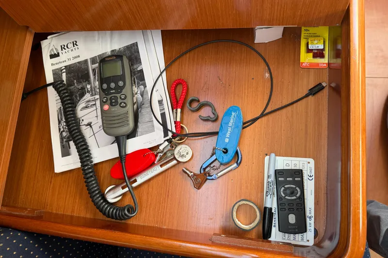 Slide: The Image of Drawer with Beneteau 31 manual, radio, keys, and tools, 2008 model. - 53