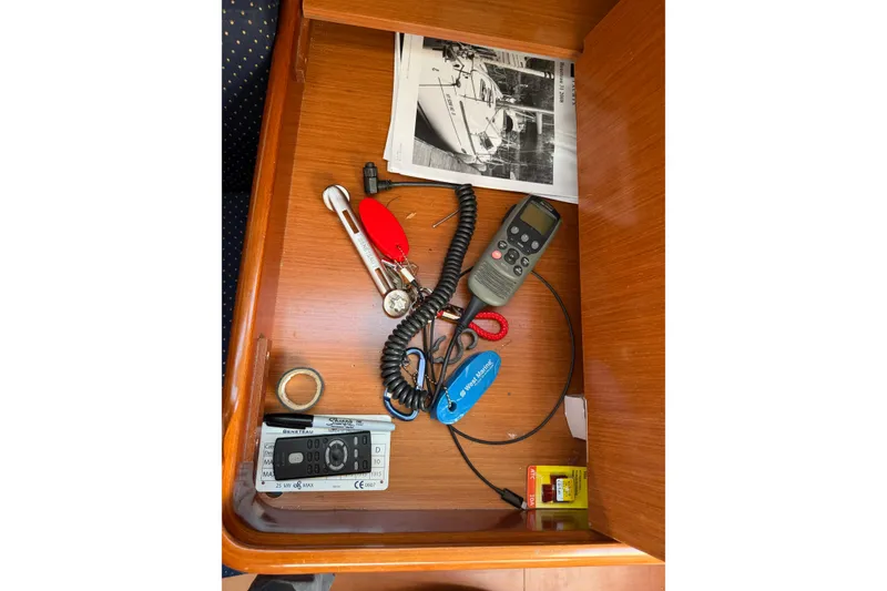 Slide: The Image of Drawer with tools and manuals for a 2008 Beneteau 31 sailboat. - 54