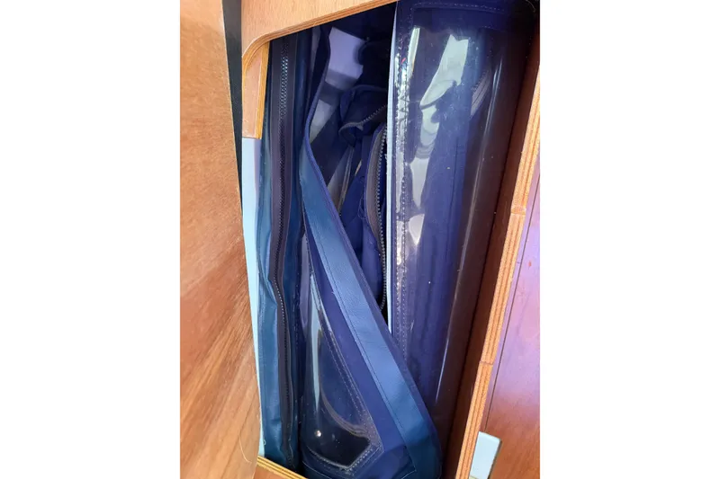 Slide: The Image of Stored blue canvas and clear plastic panels on a 2008 Beneteau 31 sailboat. - 56