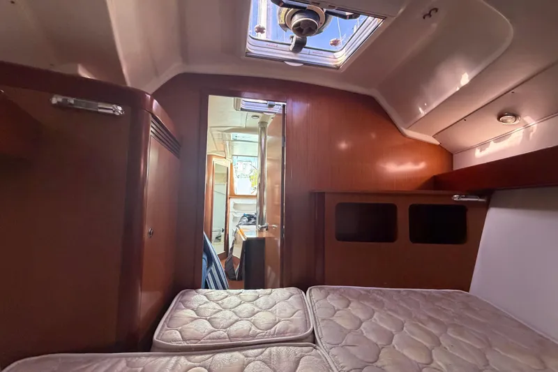 Slide: The Image of Interior cabin of 2008 Beneteau 31 sailboat with wooden finish and skylight. - 58