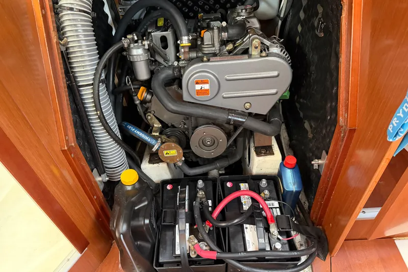 Slide: The Image of Engine compartment of a 2008 Beneteau 31 sailboat, featuring batteries and mechanical components. - 61