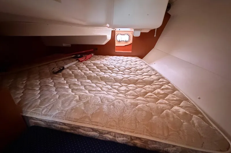 Slide: The Image of Cozy cabin interior of 2008 Beneteau 31 sailboat with mattress and window. - 65