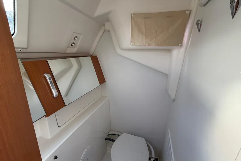Slide: The Image of 2008 Beneteau 31 yacht bathroom with mirror and compact toilet. - 68