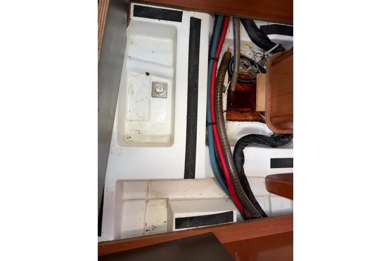 Slide: The Image of Interior view of a 2008 Beneteau 31 sailboat, showing wiring and compartments. - 72